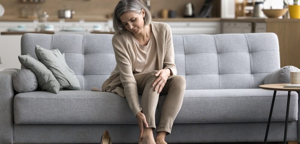 woman dealing with leg heaviness and fatigue in Maryland