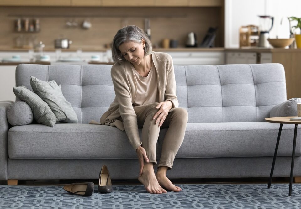 woman dealing with leg heaviness and fatigue in Maryland