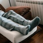 man elevating legs for good vein health