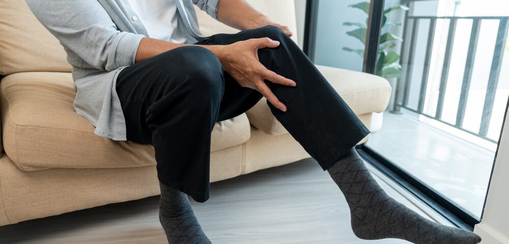 man with achy legs from varicose veins